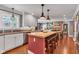 Open kitchen with a view of the brick fireplace in the living room at 900 W Busby St, Lebanon, IN 46052