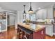 Kitchen island with counter seating, butcher block top, and stylish pendant lighting at 900 W Busby St, Lebanon, IN 46052
