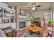 Cozy living room features a brick fireplace, built-in bookshelves, and hardwood floors at 900 W Busby St, Lebanon, IN 46052
