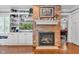Living room features a brick fireplace, built-in shelving, and ample natural light at 900 W Busby St, Lebanon, IN 46052