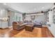 Bright living room with an L shaped sofa, grey wainscotting and hardwood floors at 900 W Busby St, Lebanon, IN 46052