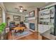 Inviting living room featuring a brick fireplace, built-in shelving, and hardwood floors at 900 W Busby St, Lebanon, IN 46052
