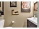 Charming powder room with modern vanity and vintage-style artwork at 900 W Busby St, Lebanon, IN 46052