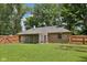 Well-kept backyard with a brick house, screened porch, and sturdy wooden fence at 9014 Holliday Dr, Indianapolis, IN 46260