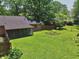 Expansive backyard featuring a screened patio and well-maintained lawn with garden beds at 9014 Holliday Dr, Indianapolis, IN 46260
