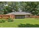 Spacious backyard featuring a well-maintained lawn, privacy fence, and the home's exterior at 9014 Holliday Dr, Indianapolis, IN 46260