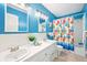 Bright bathroom with double sinks, tiled floor, and a shower/tub combo at 9014 Holliday Dr, Indianapolis, IN 46260