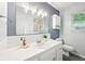 Bright bathroom with white tile, modern lighting, and a large mirror at 9014 Holliday Dr, Indianapolis, IN 46260