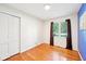 Bright bedroom with hardwood floors, neutral paint, and natural light streaming in through the window at 9014 Holliday Dr, Indianapolis, IN 46260