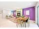 Bright dining room with colorful accent wall, fireplace, and view into a cozy living area at 9014 Holliday Dr, Indianapolis, IN 46260