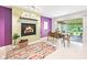 Modern dining room featuring a fireplace, colorful rug, and sliding glass doors to a screened-in porch at 9014 Holliday Dr, Indianapolis, IN 46260