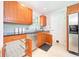 Cozy kitchen featuring sleek wooden cabinetry, stainless steel appliances, and tiled backsplash at 9014 Holliday Dr, Indianapolis, IN 46260