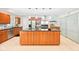 Spacious kitchen with wood cabinets, stainless steel appliances, and a large center island with seating at 9014 Holliday Dr, Indianapolis, IN 46260