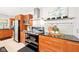 Modern kitchen featuring wood cabinets, black countertops, and stainless steel appliances at 9014 Holliday Dr, Indianapolis, IN 46260