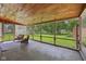 Inviting screened porch with comfortable seating and a view of the spacious backyard at 9014 Holliday Dr, Indianapolis, IN 46260