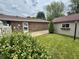 A fenced-in backyard featuring a brick home with access to a shed and well-manicured lawn at 9099 Ne Oak St, Alexandria, IN 46001