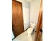 Bathroom featuring a toilet, updated fixtures, and a wooden door at 9099 Ne Oak St, Alexandria, IN 46001