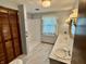 Bathroom featuring a shower, double sinks, and a stylish vanity with ample counter space at 9099 Ne Oak St, Alexandria, IN 46001