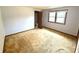 Bedroom features neutral carpet, trim, and a window for natural light at 9099 Ne Oak St, Alexandria, IN 46001