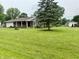 Well-kept brick home with a green lawn, mature trees, and charming curb appeal at 9099 Ne Oak St, Alexandria, IN 46001