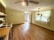 Open kitchen layout showcasing laminate flooring, countertops, and vintage-style light fixtures at 9099 Ne Oak St, Alexandria, IN 46001