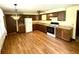 Traditional kitchen featuring wood cabinets, appliances, and durable laminate flooring at 9099 Ne Oak St, Alexandria, IN 46001