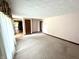 Open living room featuring neutral carpet and doorway leading to other rooms at 9099 Ne Oak St, Alexandria, IN 46001