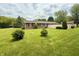 A well-manicured backyard with lush green grass and ornamental trees at 9099 Ne Oak St, Alexandria, IN 46001