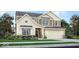 Charming two-story home with a two-car garage, a mix of siding and brick, and a well-manicured front yard at 942 Shadow Dr, Danville, IN 46122