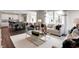 Open-concept living room features stylish furniture, an accent rug, and a view into the adjacent kitchen and dining area at 960 Shadow Dr, Danville, IN 46122
