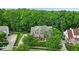 Aerial view of a home nestled among lush trees, with a well-manicured lawn and private driveway at 9834 Belcrest Ln, Indianapolis, IN 46256