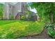 Spacious backyard features a deck and lush green grass with surrounding trees and landscaping at 9834 Belcrest Ln, Indianapolis, IN 46256