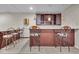 Finished basement bar with stools and cabinet space at 9834 Belcrest Ln, Indianapolis, IN 46256