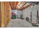 Unfinished basement with exposed framing, concrete floor, and workout equipment at 9834 Belcrest Ln, Indianapolis, IN 46256