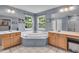 Large bathroom featuring a soaking tub, double vanity, and abundant natural light at 9834 Belcrest Ln, Indianapolis, IN 46256