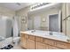 This bathroom is equipped with double sinks and a shower over tub at 9834 Belcrest Ln, Indianapolis, IN 46256