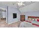 Cozy bedroom featuring carpet floors, ceiling fan, and a mounted TV at 9834 Belcrest Ln, Indianapolis, IN 46256