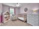 Serene Bedroom with soft pink walls, crib, glider, and mountain-themed decor at 9834 Belcrest Ln, Indianapolis, IN 46256