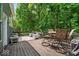 Inviting backyard deck with wooden flooring and a cozy seating area, surrounded by lush greenery at 9834 Belcrest Ln, Indianapolis, IN 46256