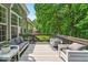 Relaxing deck area features comfortable seating and a view of the green trees, offering a private outdoor retreat at 9834 Belcrest Ln, Indianapolis, IN 46256