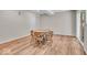 Bright dining area features wood floors and a table with seating for four, flooded with natural light at 9834 Belcrest Ln, Indianapolis, IN 46256