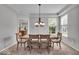 Elegant dining room with natural light, rustic table and chairs, and tray ceiling at 9834 Belcrest Ln, Indianapolis, IN 46256