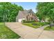 Spacious home with driveway, basketball court, attached garage, and beautifully landscaped front yard at 9834 Belcrest Ln, Indianapolis, IN 46256