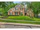 Charming brick two-story home with well-manicured lawn, lush landscaping, and classic architectural details at 9834 Belcrest Ln, Indianapolis, IN 46256