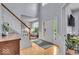 Bright foyer with hardwood floors, staircase, and view to living room creates an inviting entrance at 9834 Belcrest Ln, Indianapolis, IN 46256