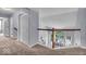 Hallway with carpet and a view of the living room on the lower floor at 9834 Belcrest Ln, Indianapolis, IN 46256