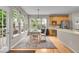 Eat-in kitchen featuring hardwood floors, lots of windows and light-colored cabinets at 9834 Belcrest Ln, Indianapolis, IN 46256