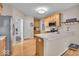 Kitchen with stainless appliances, light-colored cabinets, and hardwood floors at 9834 Belcrest Ln, Indianapolis, IN 46256
