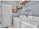 Functional laundry room with washer, dryer, and shelving for storage at 9834 Belcrest Ln, Indianapolis, IN 46256