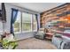 Cozy living room with a unique wood accent wall and comfortable seating with natural light at 9834 Belcrest Ln, Indianapolis, IN 46256